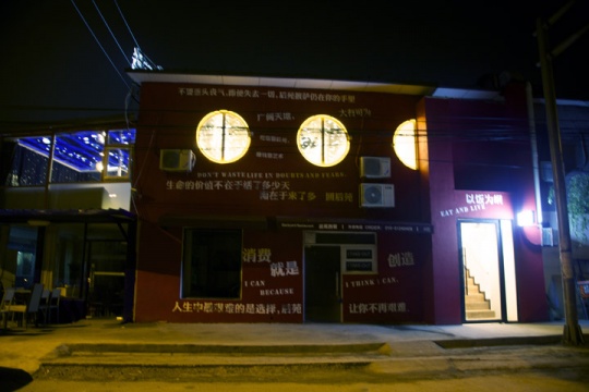 大紅色外墻和口號式標語讓后苑西餐極為扎眼
